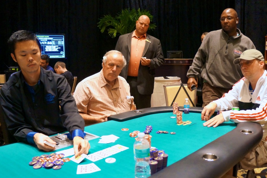 Greg Lehn (seated, center) doubles thru Derrick Cutler (standing, right).